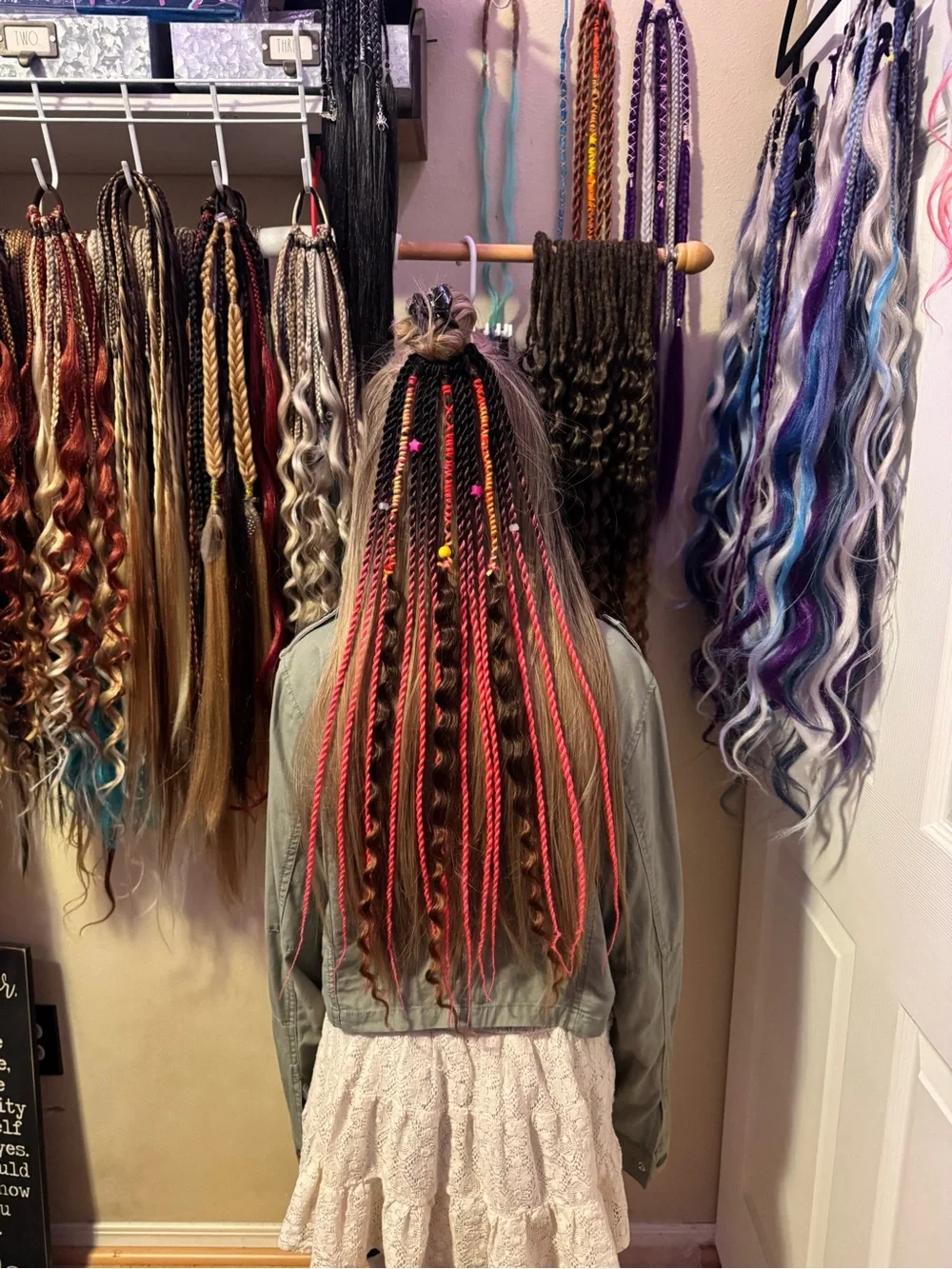 Hand-Braided Hair Extensions with Bright Pink Accents